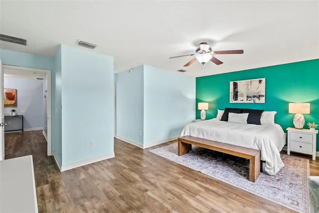 a bedroom with a bed and a bookshelf