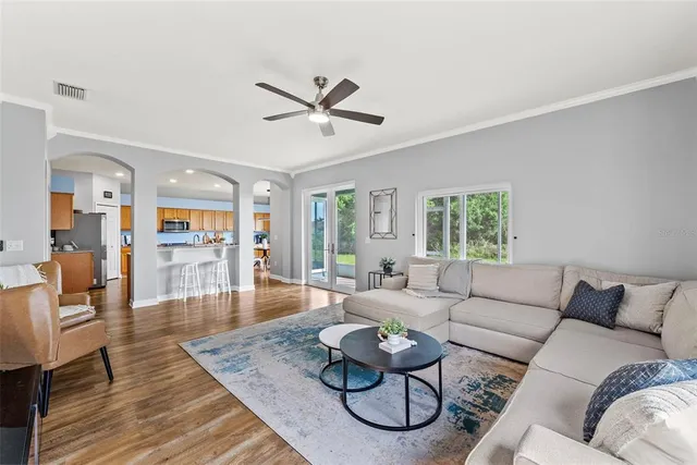 a living room with furniture and wooden floor