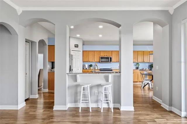 a kitchen with stainless steel appliances granite countertop wooden cabinets a sink and a stove