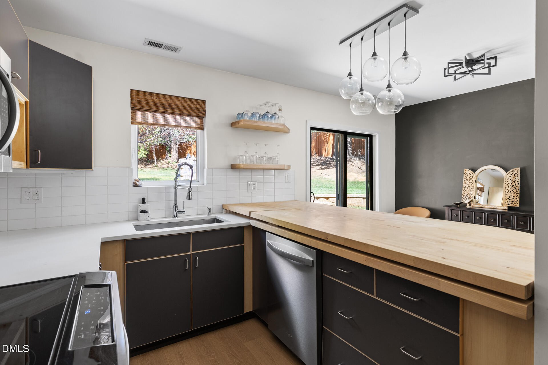 5208 Saddle Court Raleigh, NC 27609 - Photo 13 of 43 a kitchen with a sink and a stove