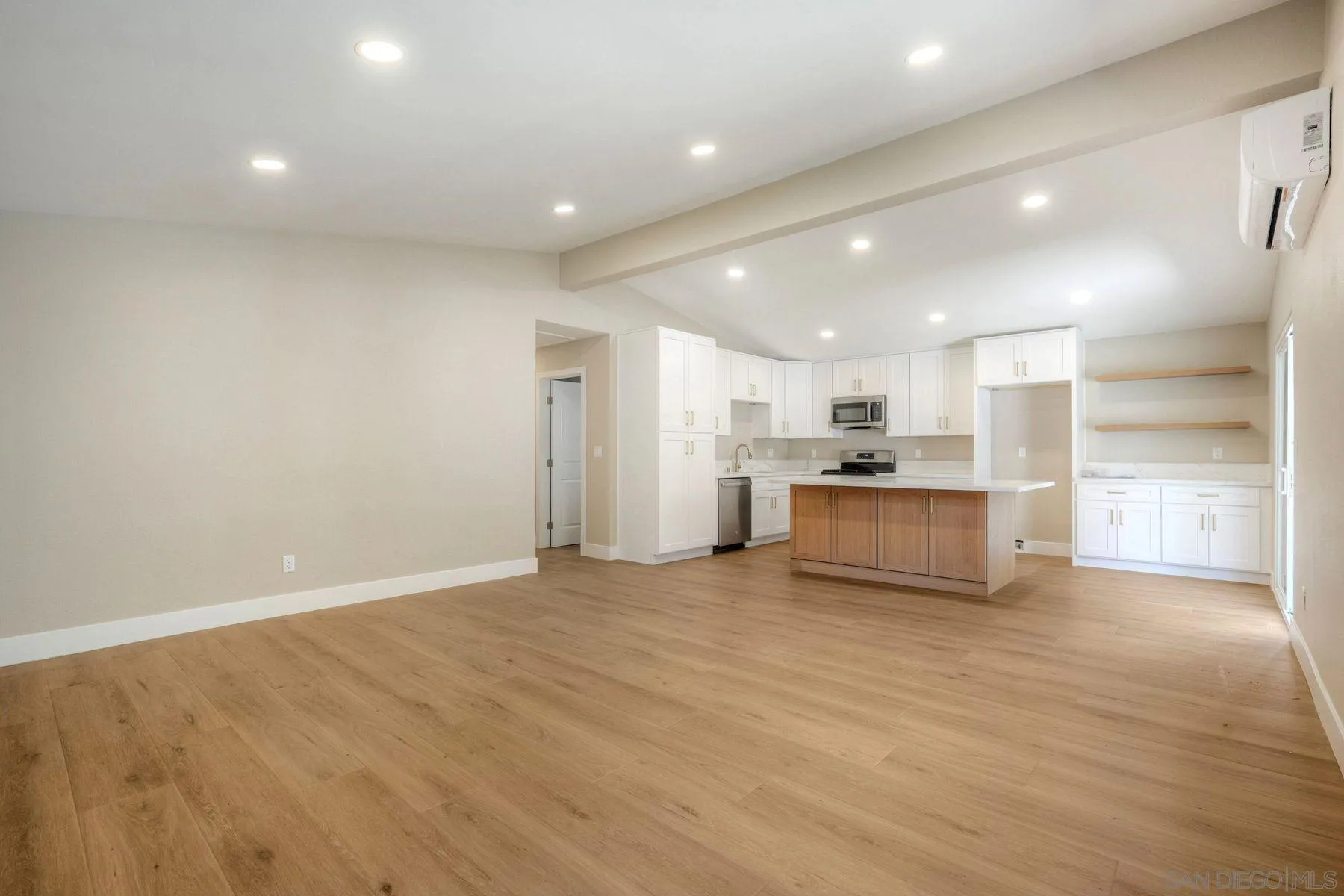 578 East Indian Rock Road Vista, CA 92084 - Photo 22 of 30 a view of kitchen with kitchen island a sink wooden floor and a refrigerator