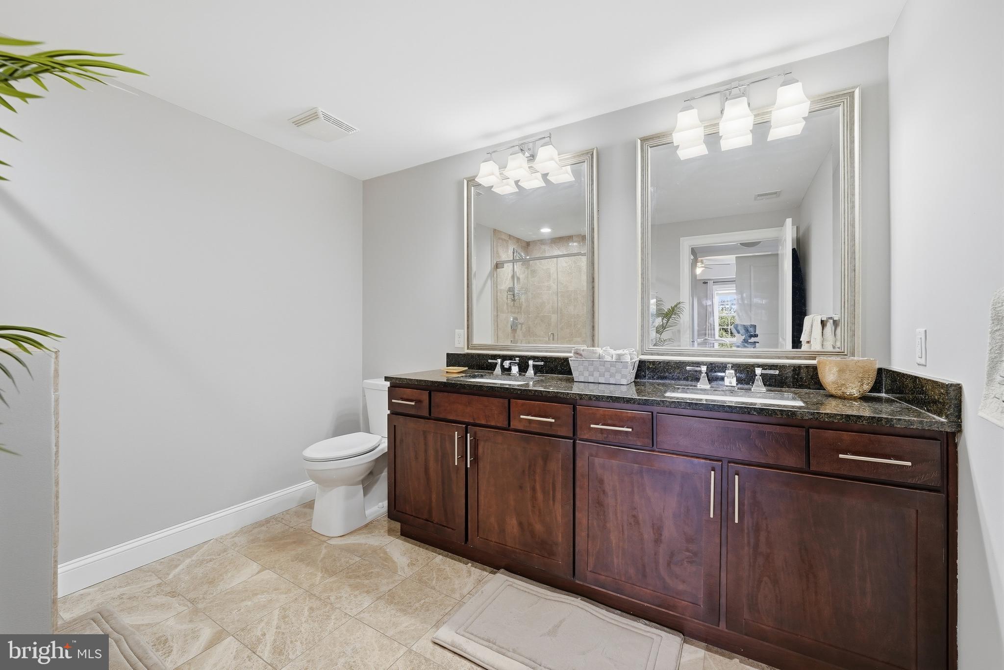 6301 Edsall Road, Unit 519 Alexandria, VA 22312 - Photo 16 of 33 a bathroom with a granite countertop toilet sink and mirror