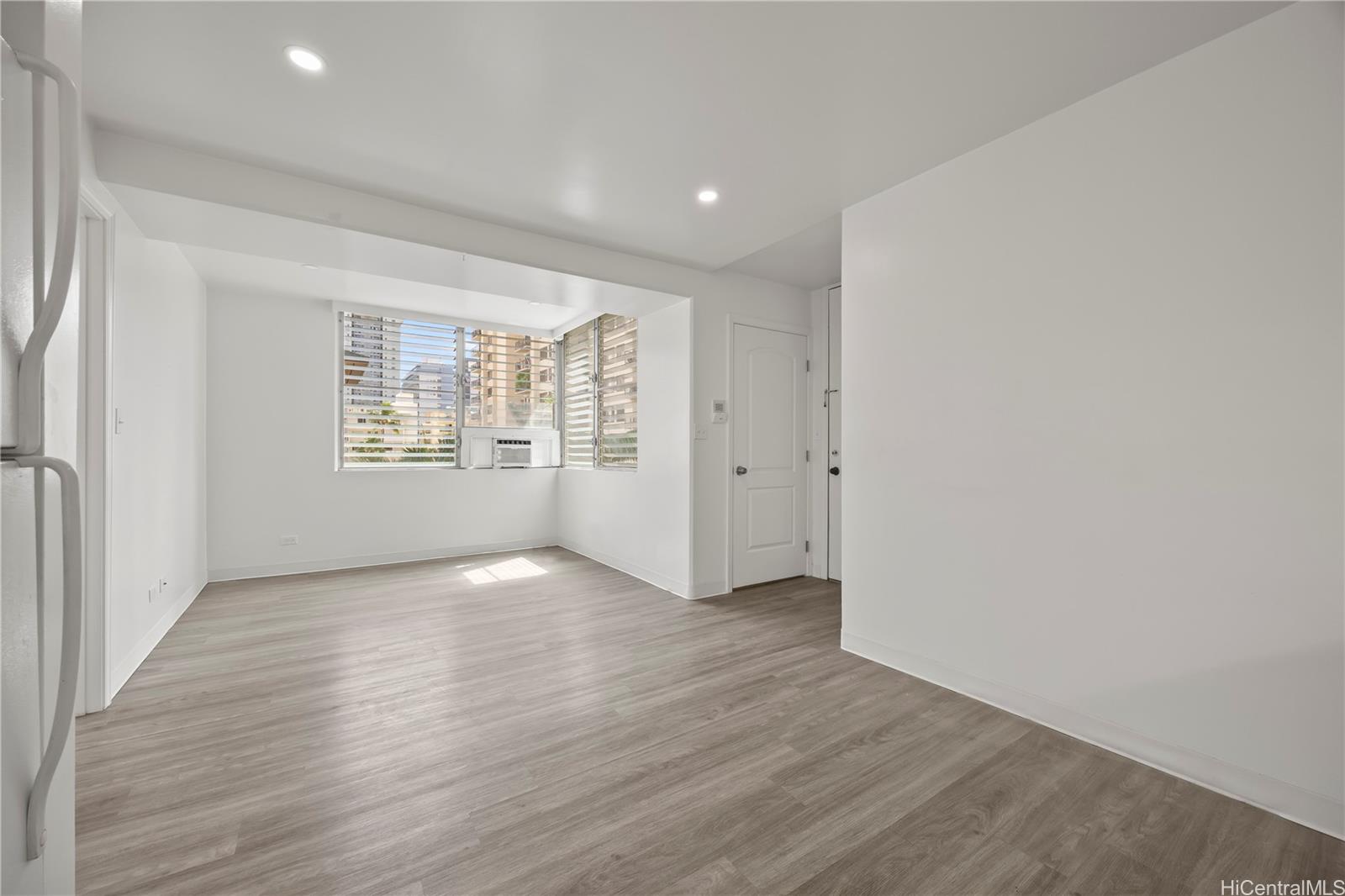 412 Launiu Street Honolulu, HI 96815 - Photo 13 of 20 an empty room with wooden floor and windows