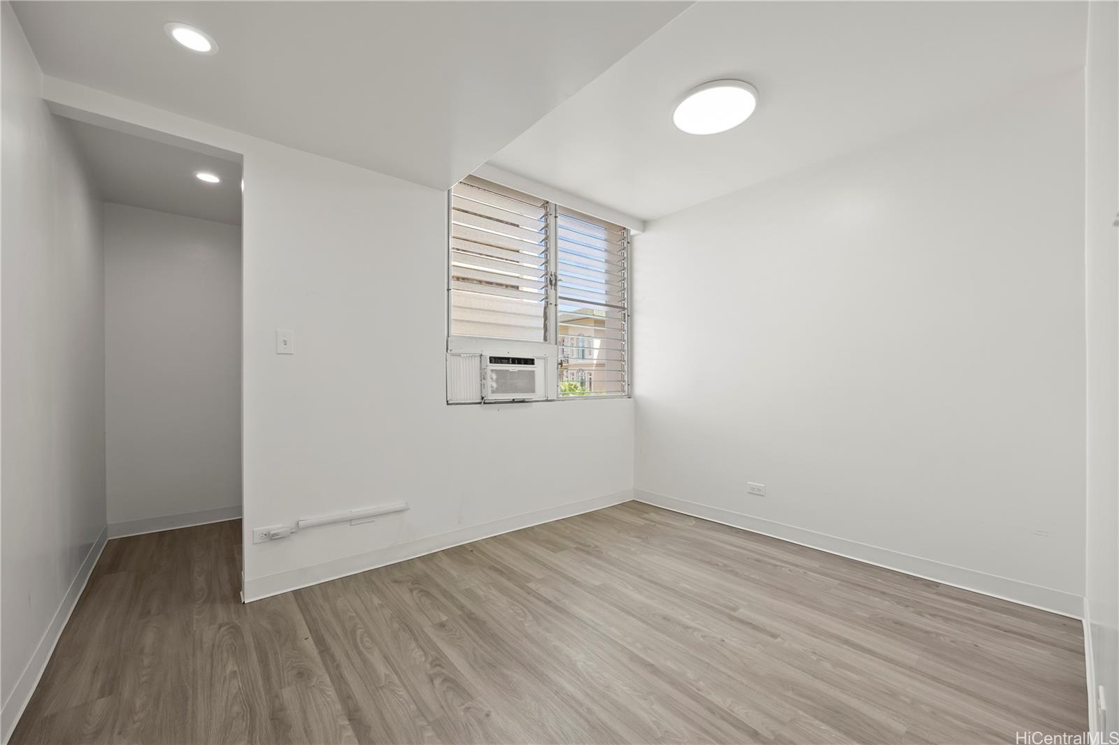412 Launiu Street Honolulu, HI 96815 - Photo 15 of 20 an empty room with wooden floor and windows