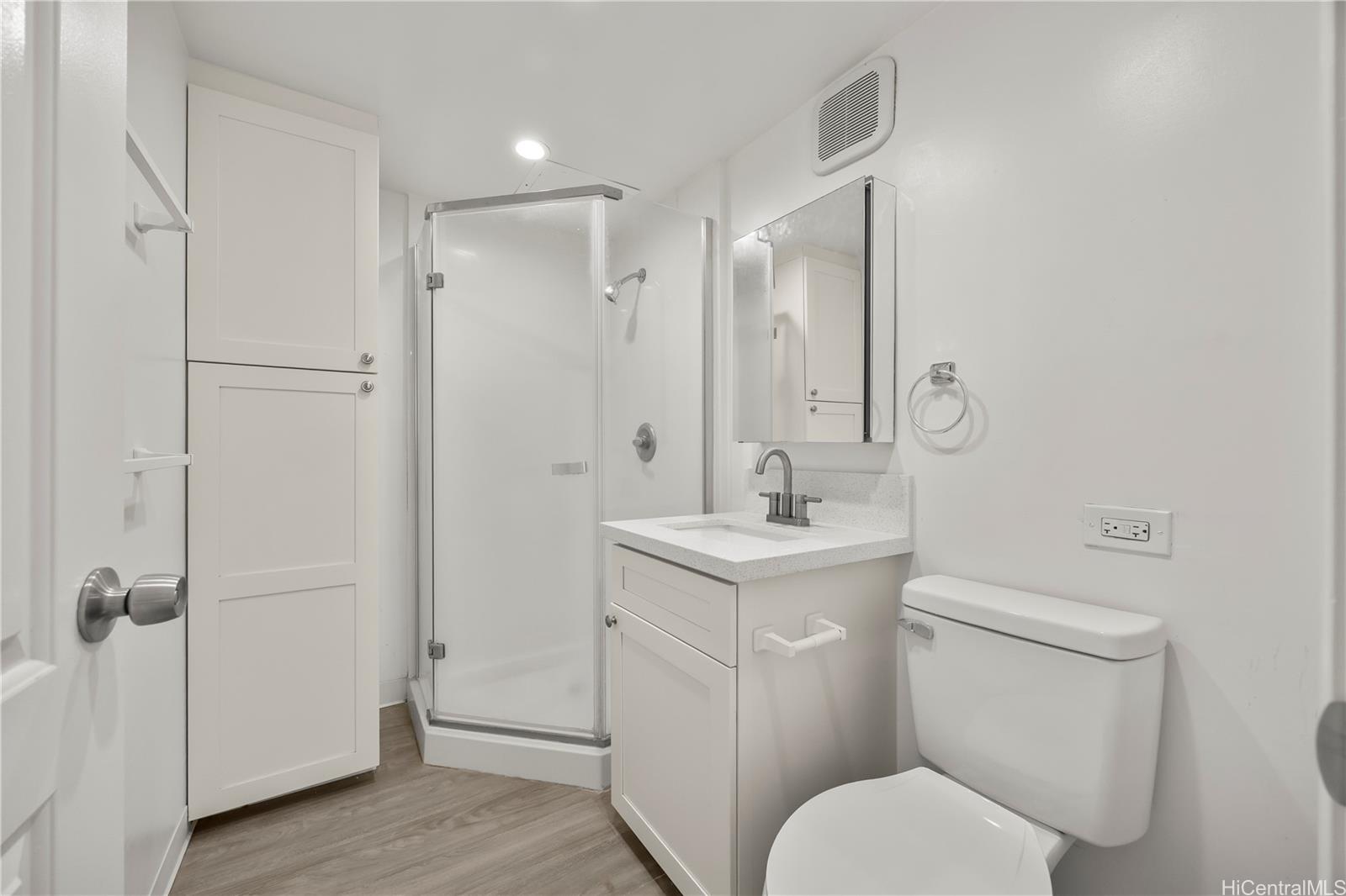412 Launiu Street Honolulu, HI 96815 - Photo 16 of 20 a bathroom with a toilet sink vanity and shower