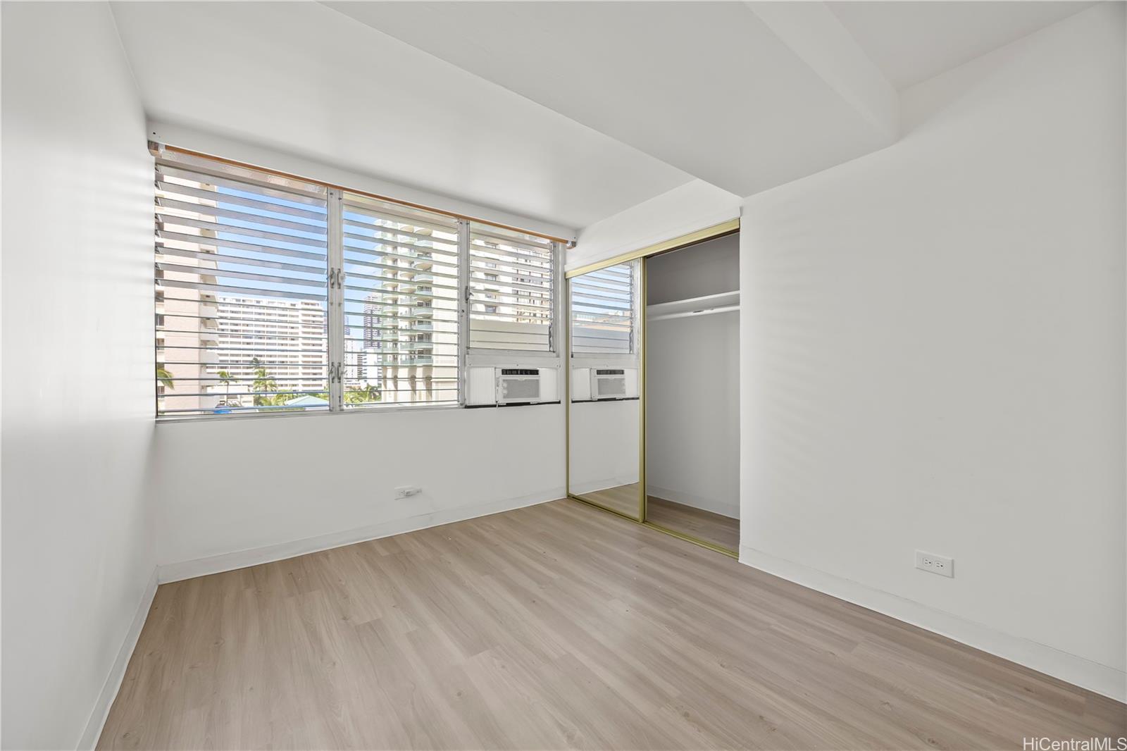 412 Launiu Street Honolulu, HI 96815 - Photo 7 of 20 an empty room with wooden floor and windows