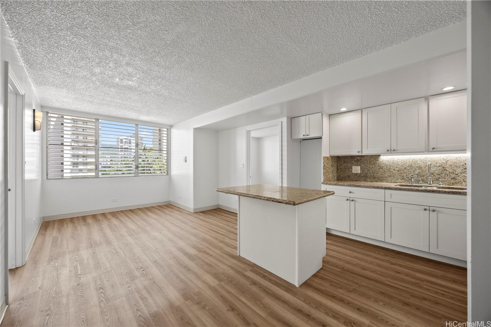 412 Launiu Street Honolulu, HI 96815 - Photo 8 of 20 a kitchen with stainless steel appliances granite countertop a stove a sink and white cabinets