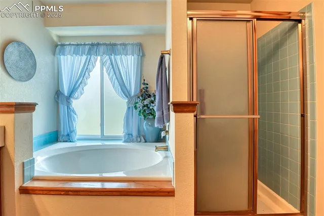 a view of bathroom with bathtub and mirror