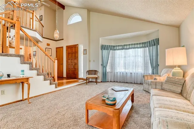 a living room with furniture a large window and couch