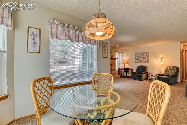 a living room with fireplace furniture and a chandelier