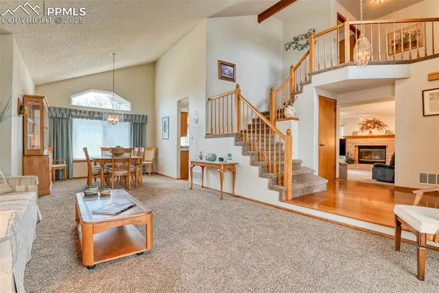 a living room with furniture and a chandelier