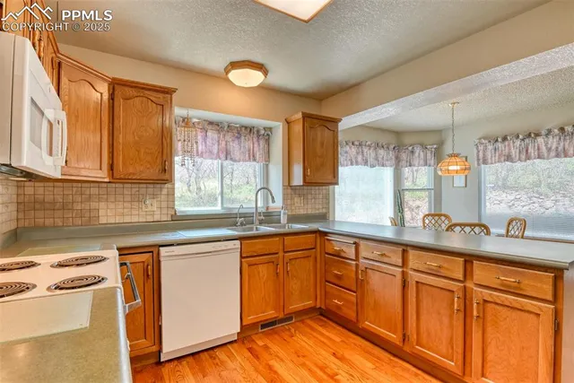 a kitchen with stainless steel appliances granite countertop a sink and cabinets