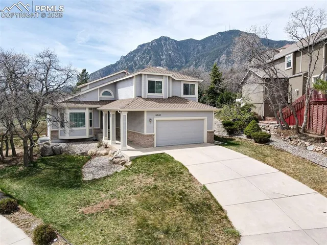 a front view of house with yard and trees around