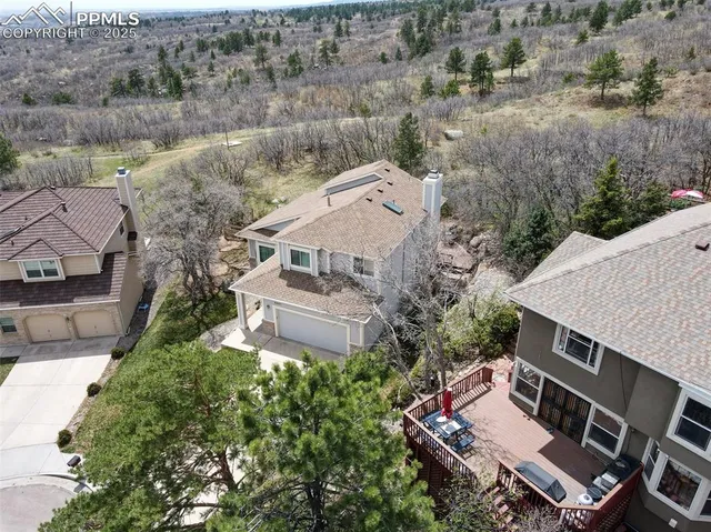an aerial view of a house with a yard