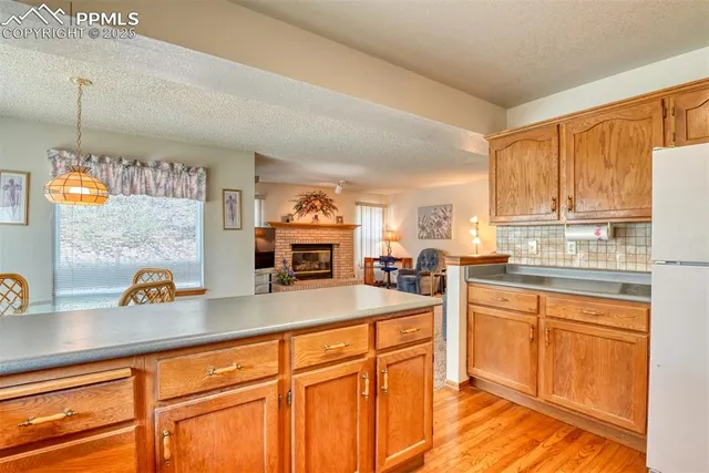 a kitchen with stainless steel appliances granite countertop a sink a stove and a wooden cabinets