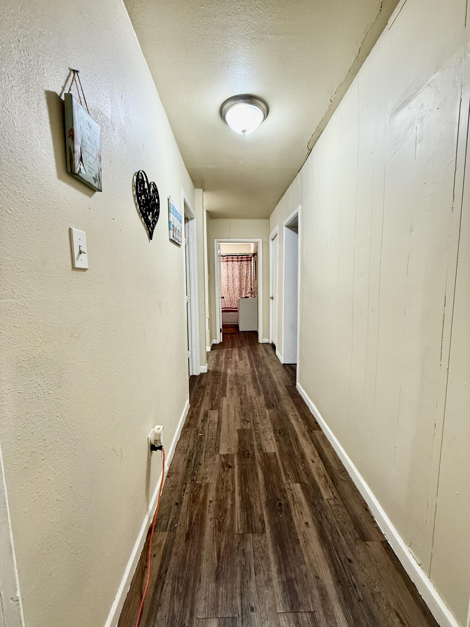 3708 Elgin Avenue Lubbock, TX 79413 - Photo 13 of 23 a view of a hallway with wooden floor and staircase