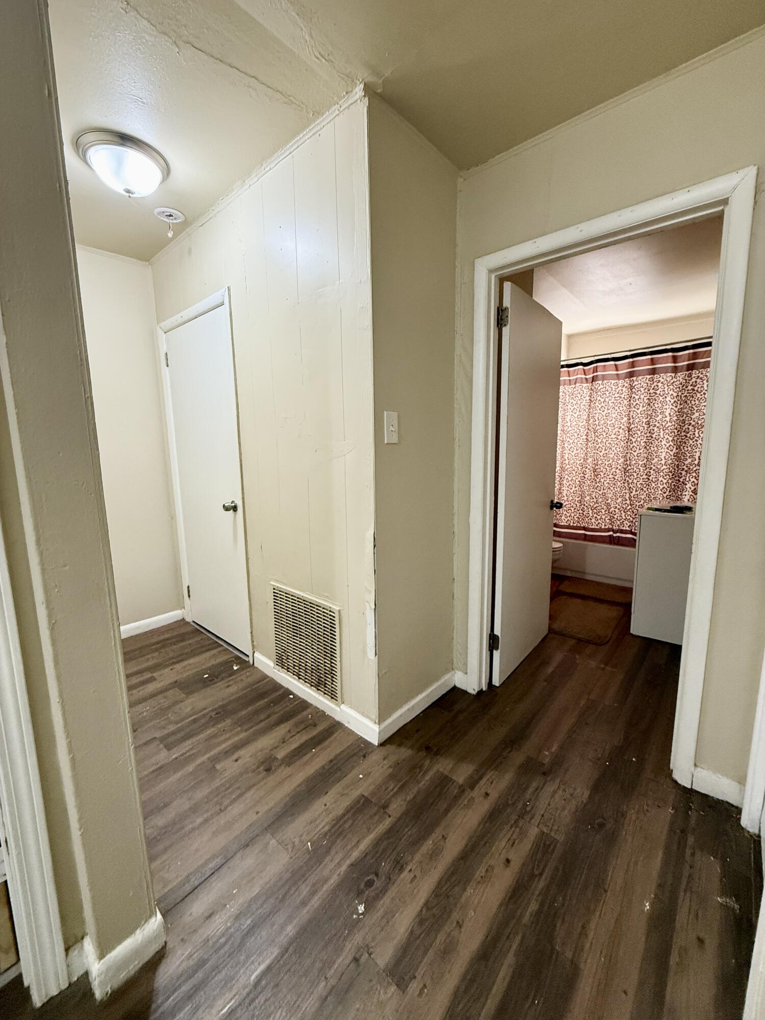 3708 Elgin Avenue Lubbock, TX 79413 - Photo 16 of 23 a view of an empty room with wooden floor