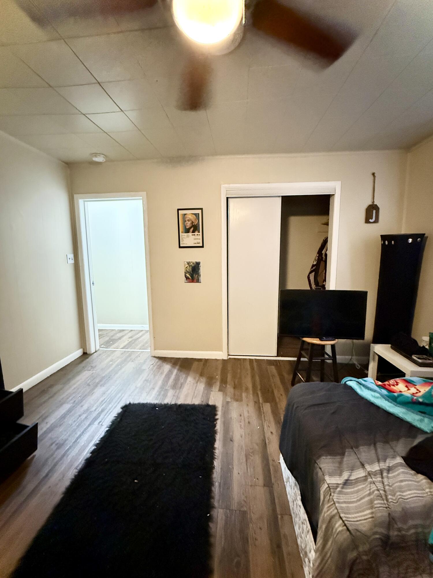 3708 Elgin Avenue Lubbock, TX 79413 - Photo 17 of 23 a bedroom with a bed and a computer on the desk next to a window