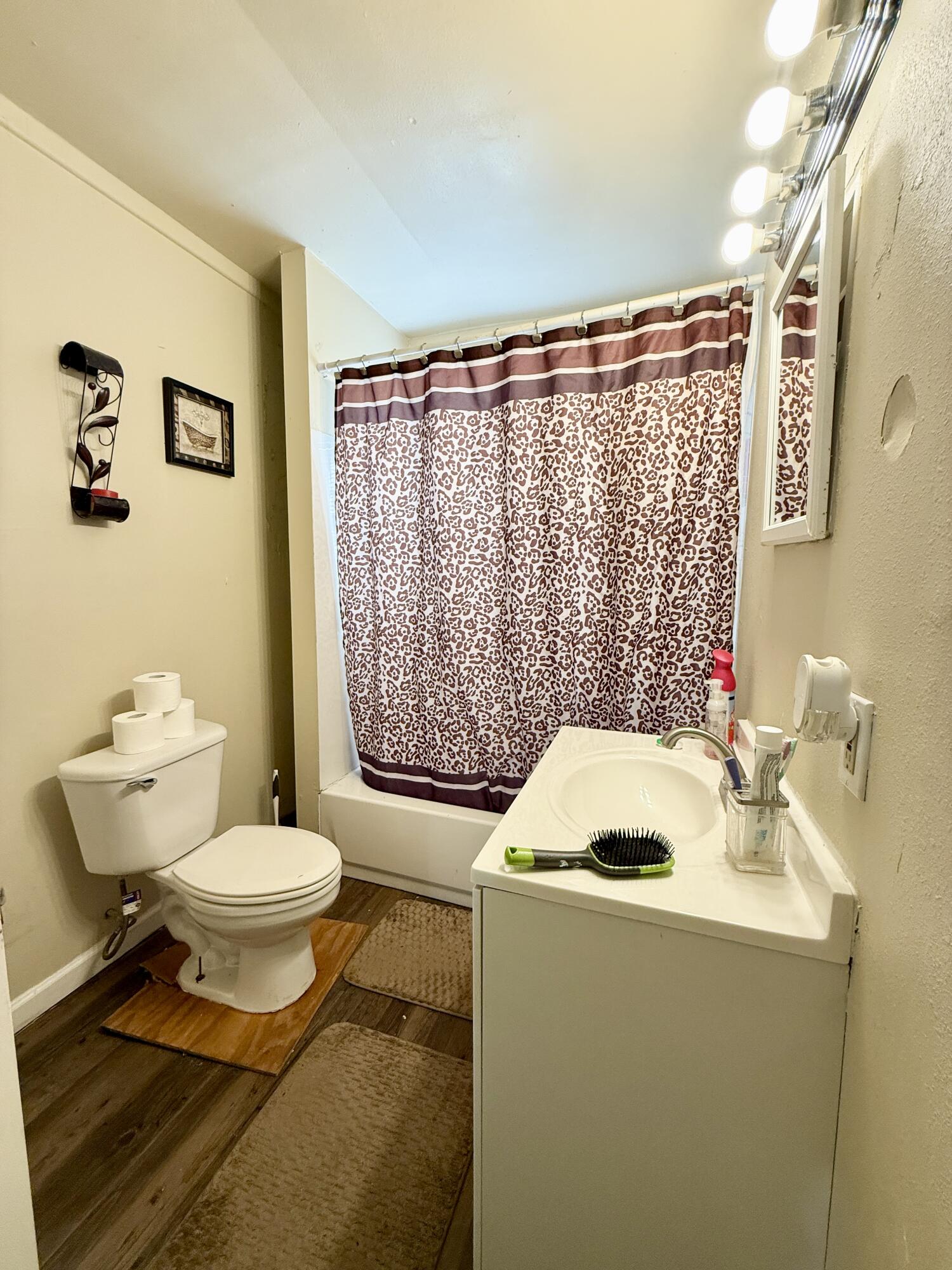 3708 Elgin Avenue Lubbock, TX 79413 - Photo 19 of 23 a bathroom with a sink toilet and shower