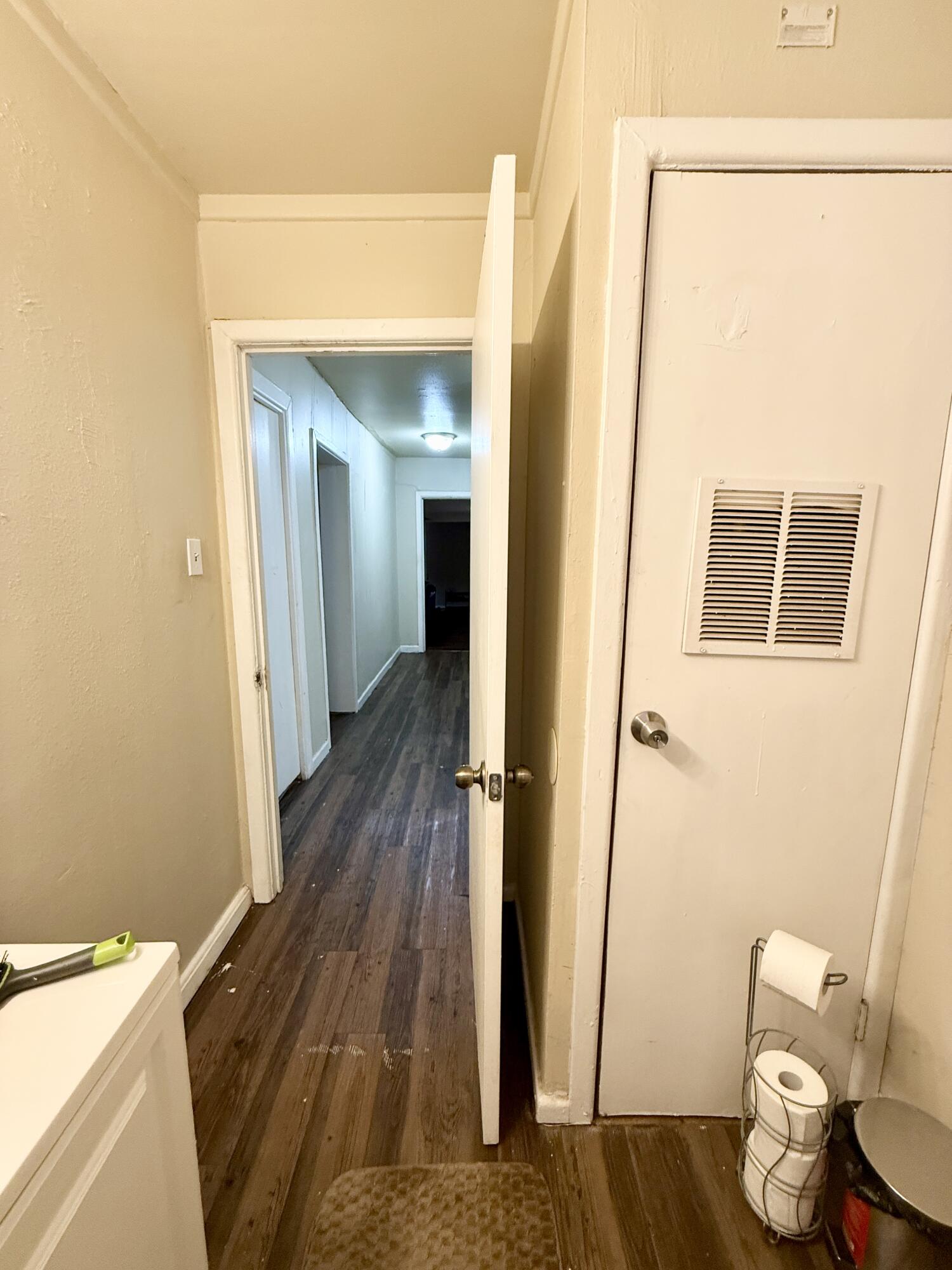 3708 Elgin Avenue Lubbock, TX 79413 - Photo 20 of 23 a view of a hallway with wooden floor and furniture