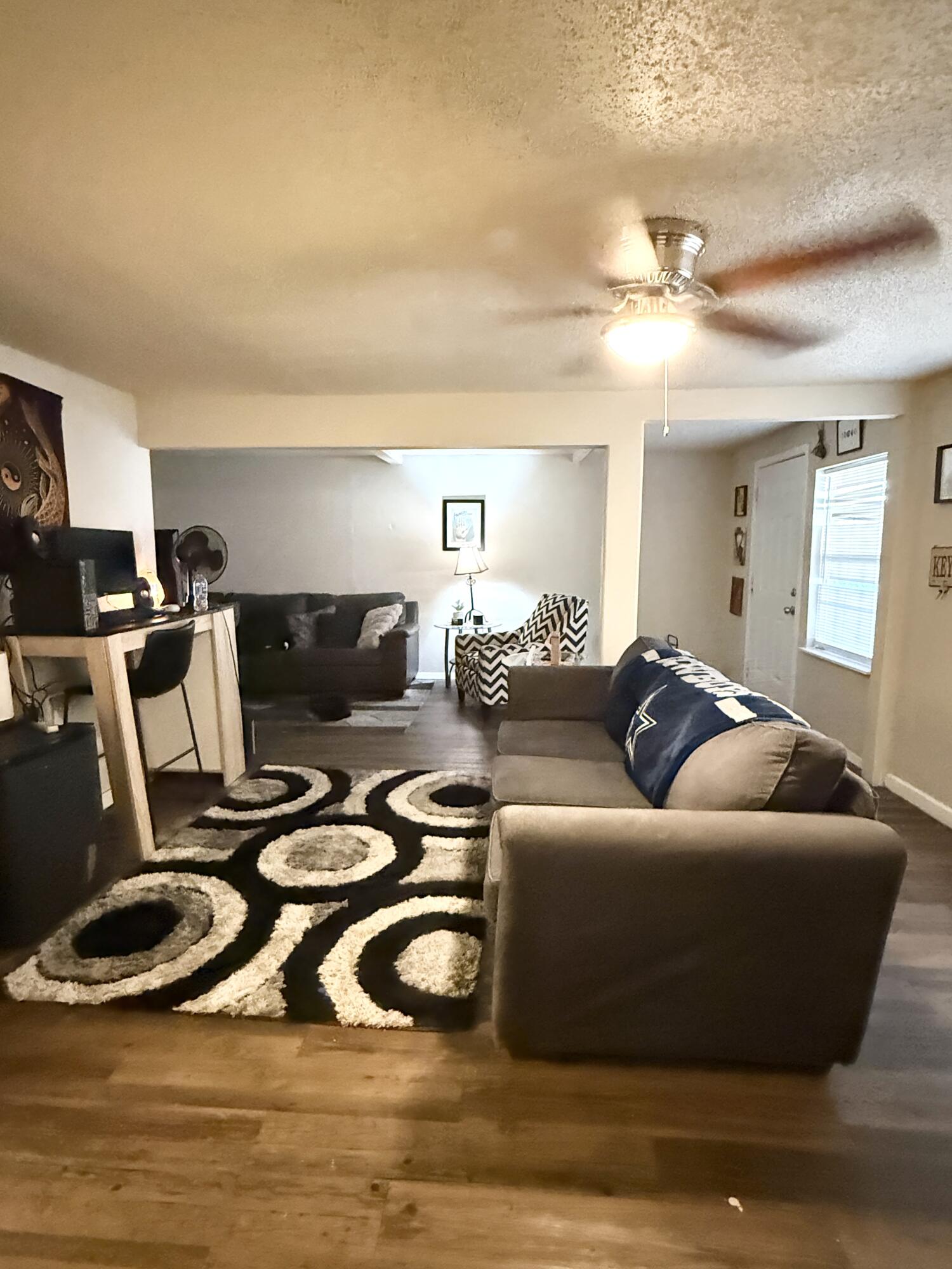 3708 Elgin Avenue Lubbock, TX 79413 - Photo 4 of 23 a living room with furniture a flat screen tv and a window