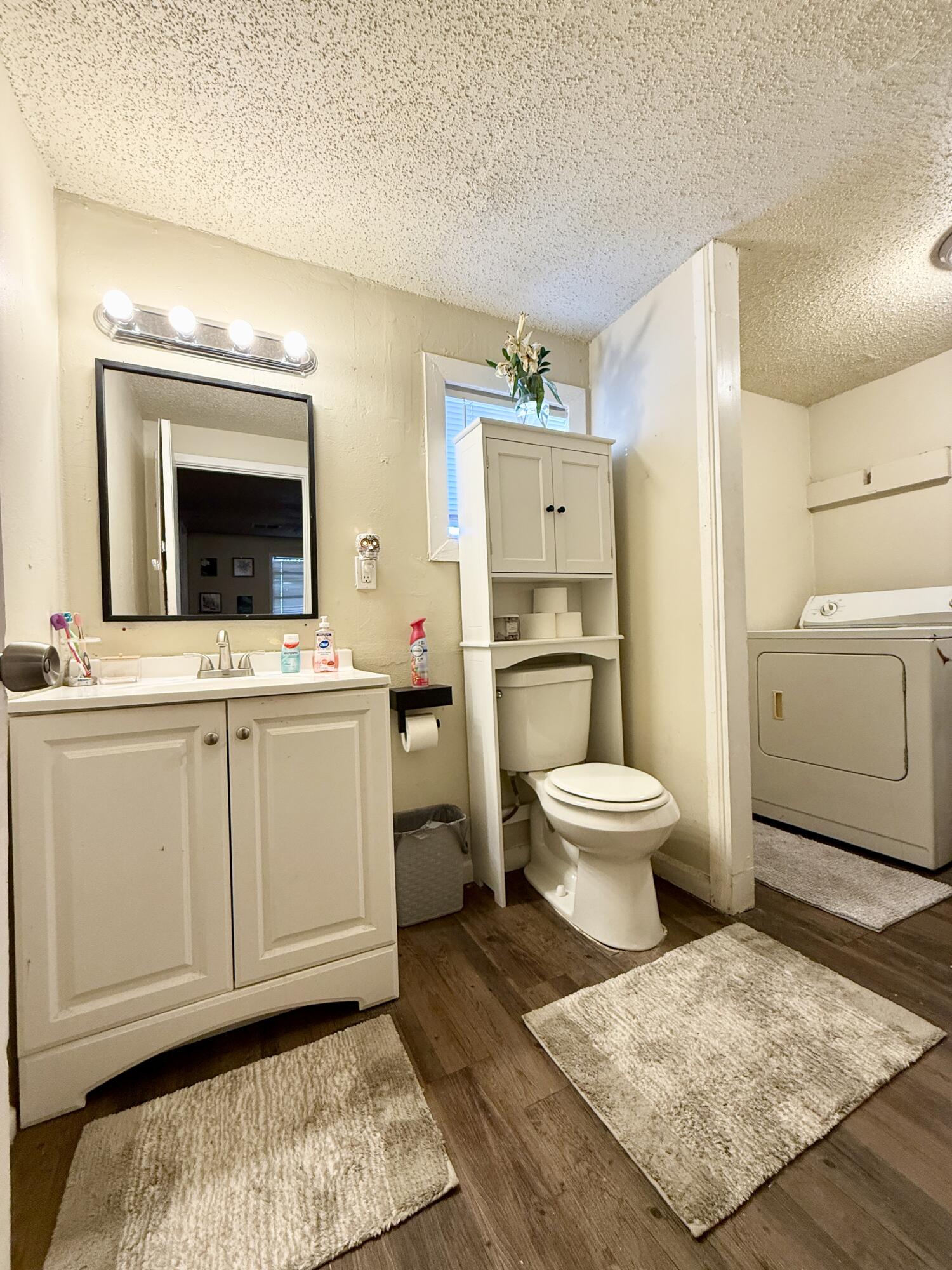 3708 Elgin Avenue Lubbock, TX 79413 - Photo 6 of 23 a bathroom with a sink toilet and mirror