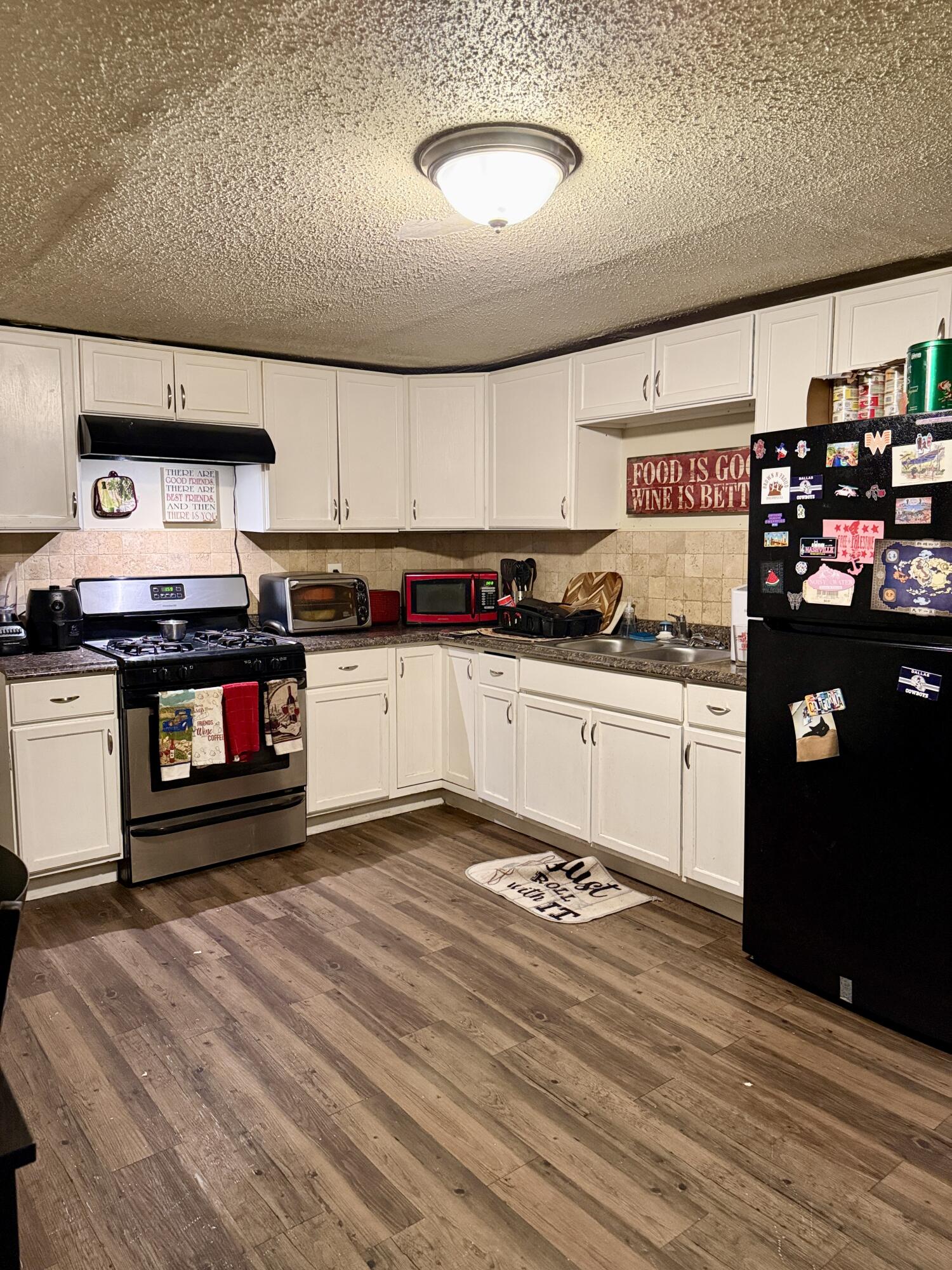 3708 Elgin Avenue Lubbock, TX 79413 - Photo 9 of 23 a kitchen with stainless steel appliances granite countertop a stove a sink and a refrigerator