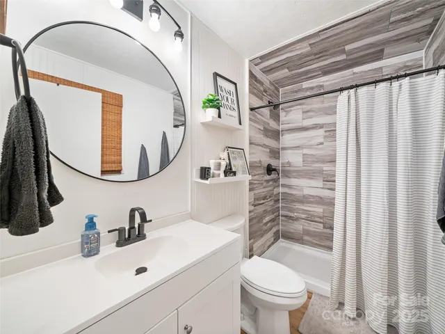 a bedroom with a bed and painting on the wall