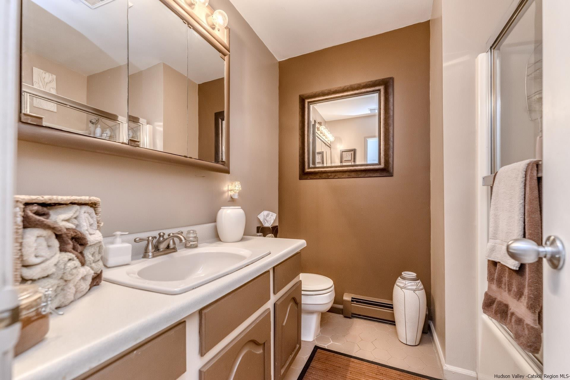 195 Arnold Drive Kingston, NY 12401 - Photo 20 of 35 a bathroom with a granite countertop sink a toilet and a mirror