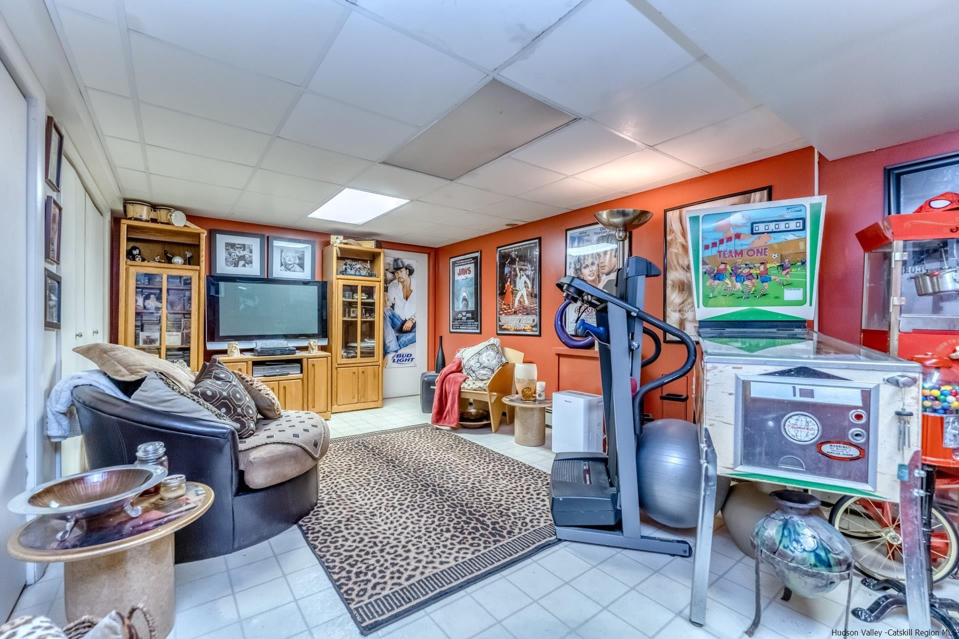 195 Arnold Drive Kingston, NY 12401 - Photo 23 of 35 a living room with furniture a flat screen tv and a floor to ceiling window