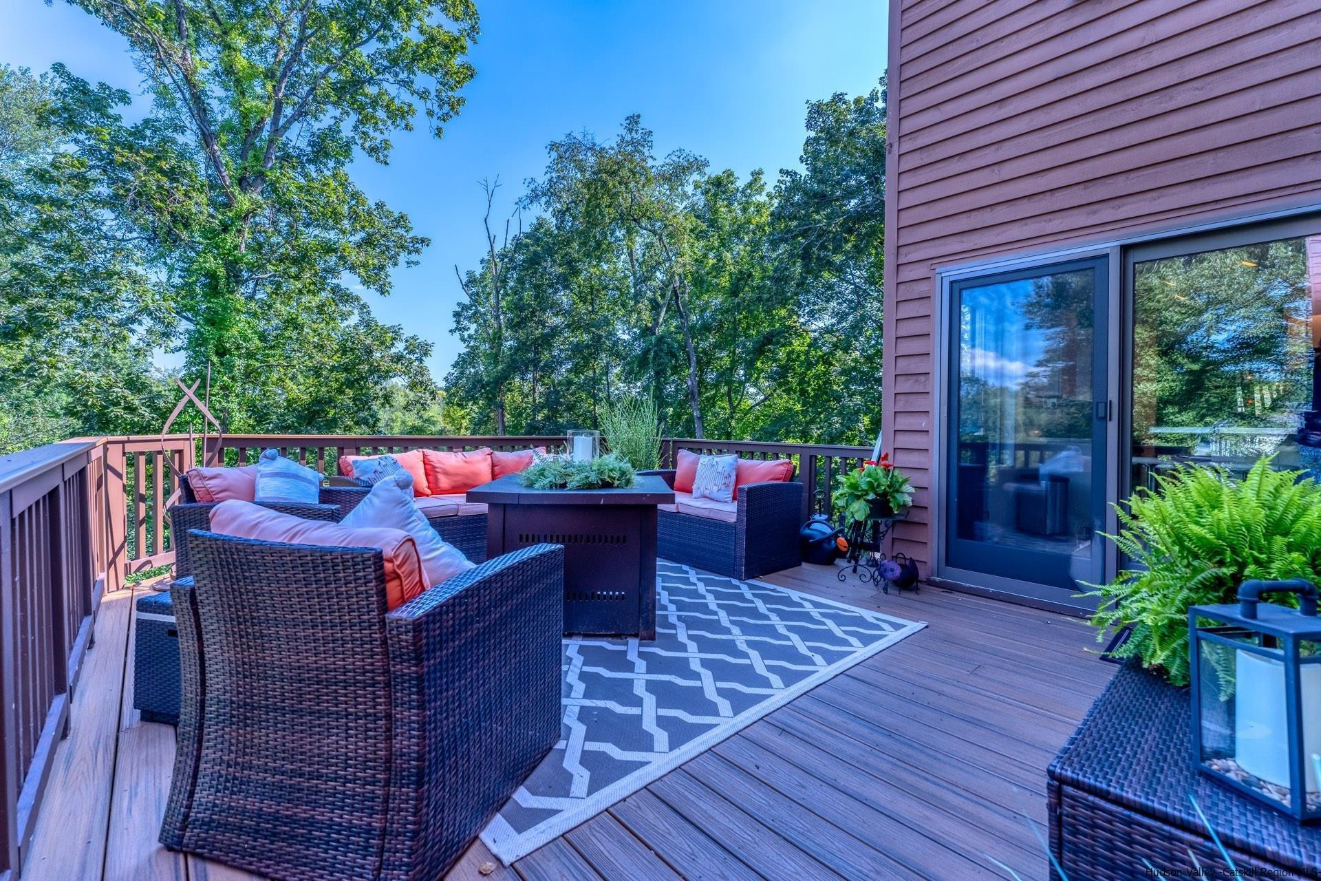 195 Arnold Drive Kingston, NY 12401 - Photo 28 of 35 a view of a patio with table and chairs potted plants with wooden floor and fence