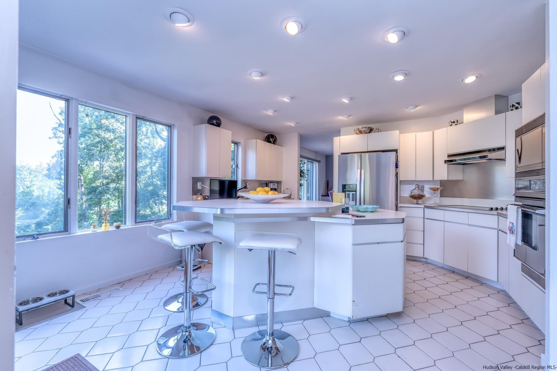 195 Arnold Drive Kingston, NY 12401 - Photo 7 of 35 a kitchen with stainless steel appliances granite countertop a sink a stove a refrigerator and chairs