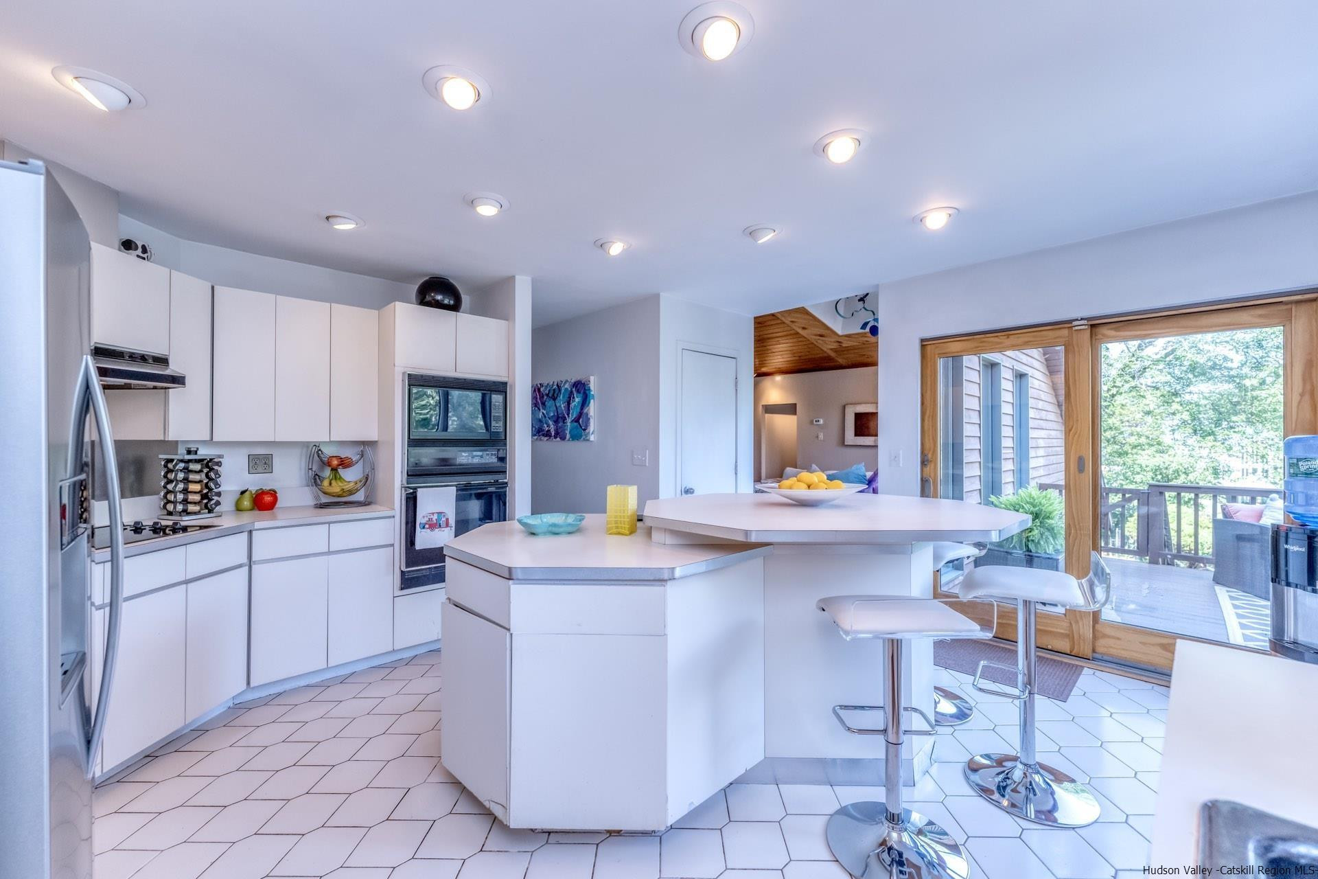 195 Arnold Drive Kingston, NY 12401 - Photo 8 of 35 a kitchen with stainless steel appliances granite countertop a refrigerator a sink dishwasher a dining table and chairs with wooden floor