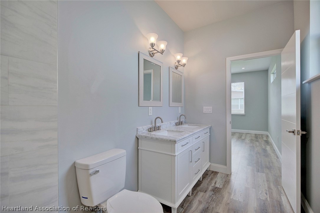 2545 Odessa Road Avon Park, FL 33825 - Photo 15 of 24 a bathroom with a toilet sink and mirror