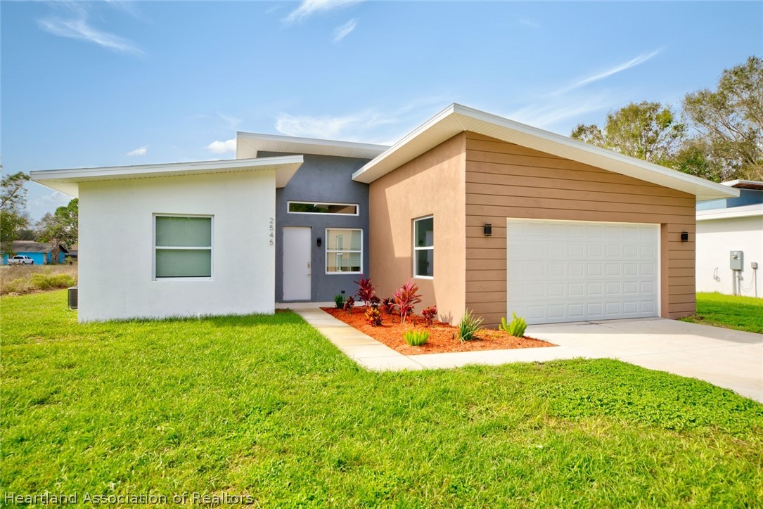 2545 Odessa Road Avon Park, FL 33825 - Photo 2 of 24 a view of a backyard with plants and patio