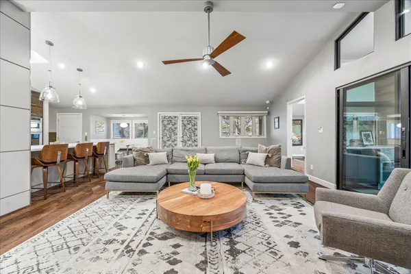 a kitchen with kitchen island a counter top space a sink stainless steel appliances and cabinets
