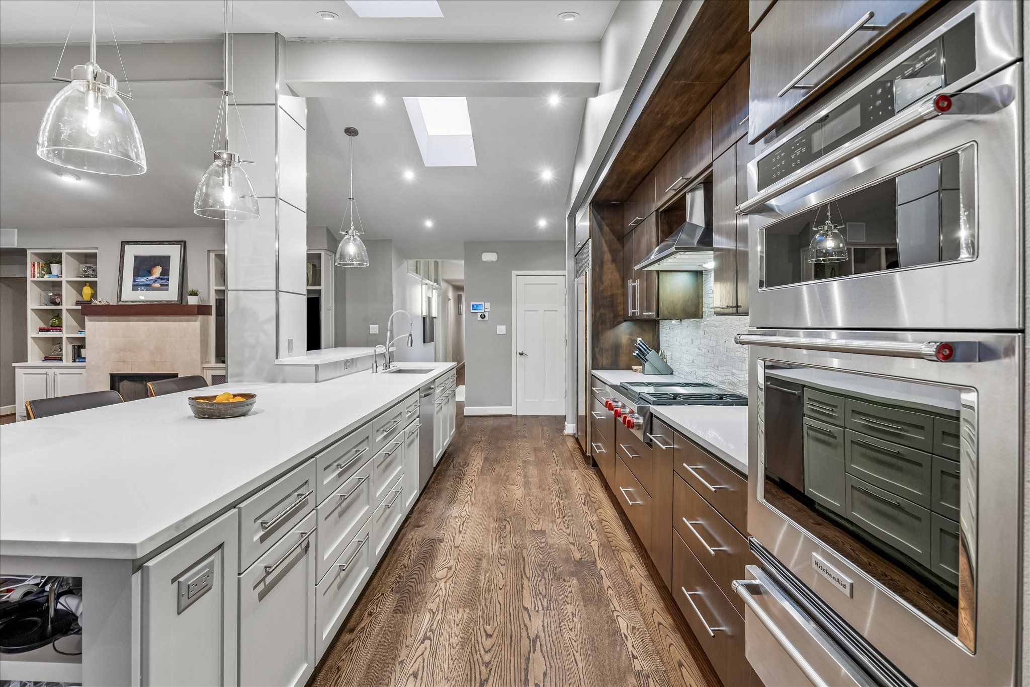 2613 Spring Lane Austin, TX 78703 - Photo 13 of 32 a large kitchen with stainless steel appliances a large counter top a stove and a chandelier