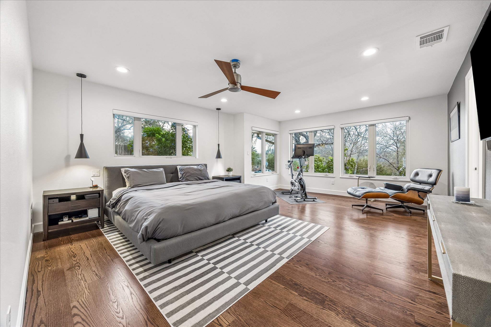 2613 Spring Lane Austin, TX 78703 - Photo 19 of 32 a spacious bedroom with a large bed and a wooden floor