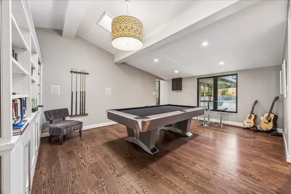a living room with wooden floor and furniture