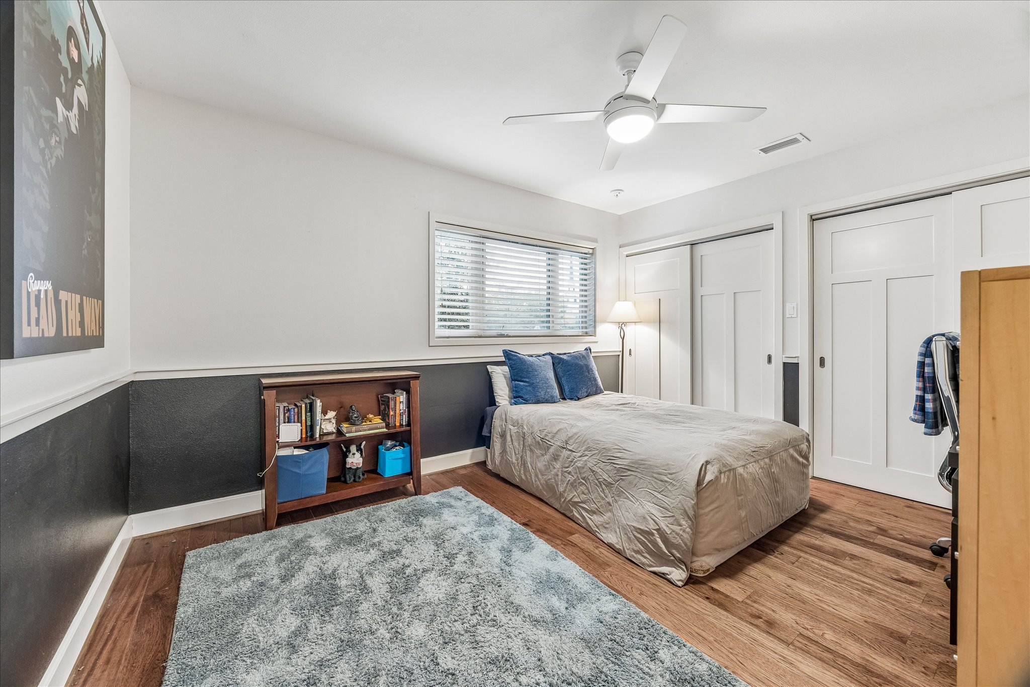 2613 Spring Lane Austin, TX 78703 - Photo 26 of 32 a bedroom with a bed and a dresser with wooden floor