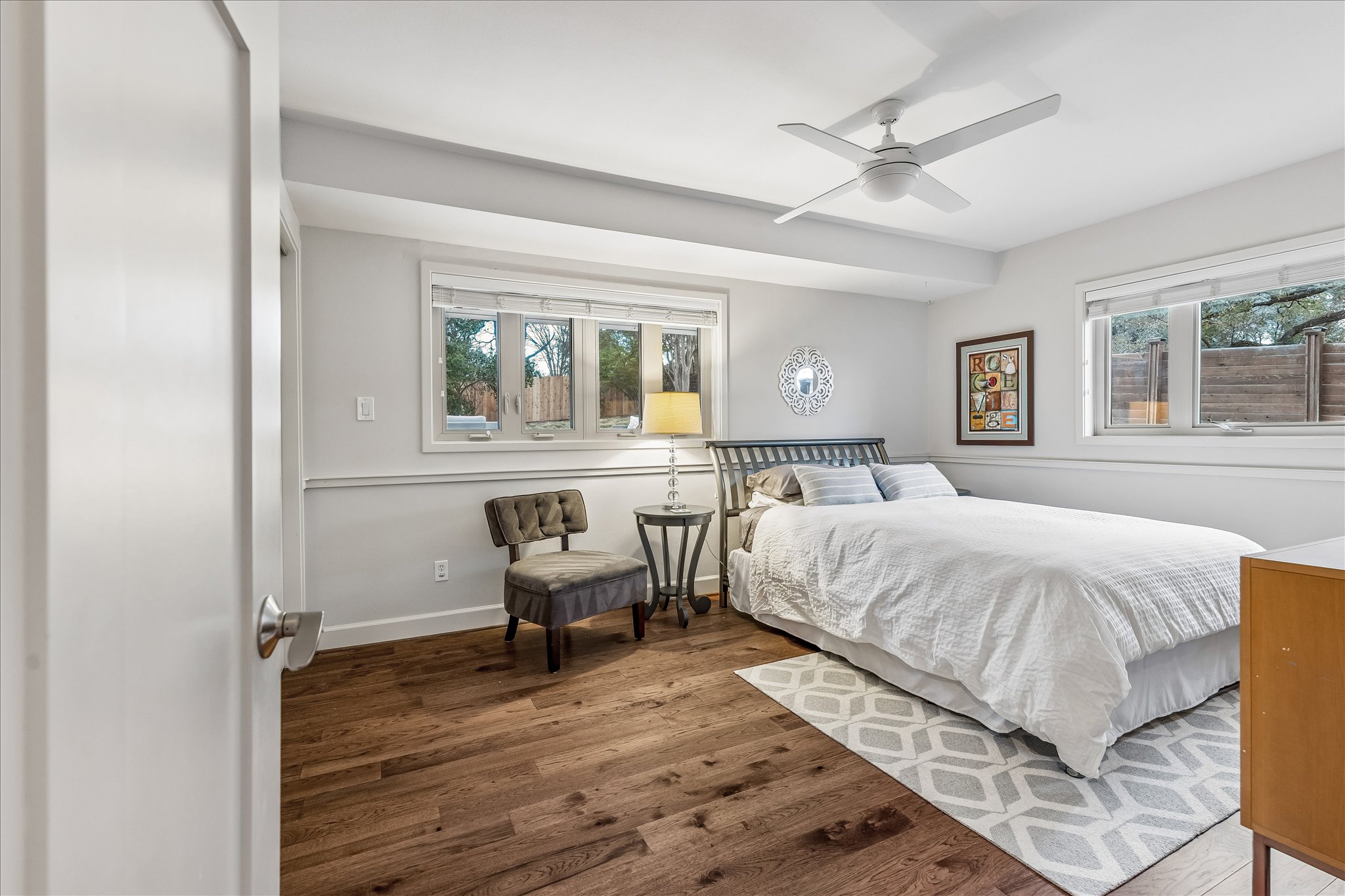 2613 Spring Lane Austin, TX 78703 - Photo 27 of 32 a bed room with a bed and a chair