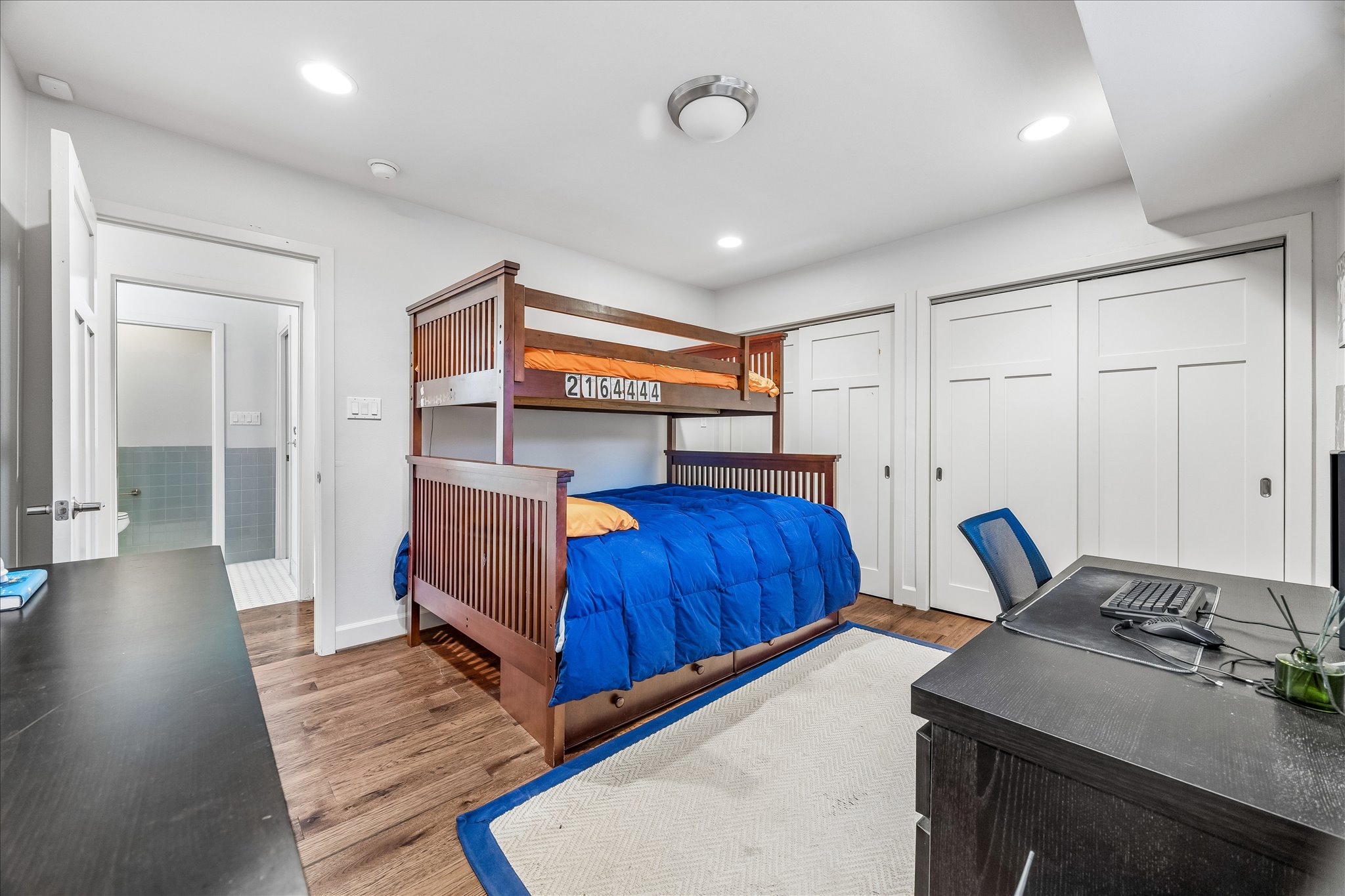 2613 Spring Lane Austin, TX 78703 - Photo 28 of 32 a bedroom with furniture and a wooden floor