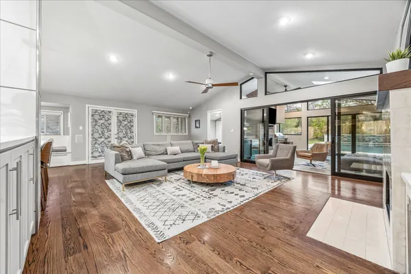 a living room with fireplace furniture and a flat screen tv