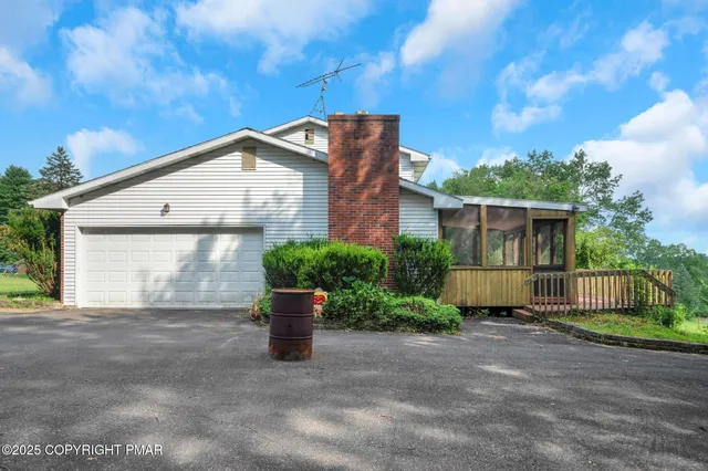 a front view of a house with plants