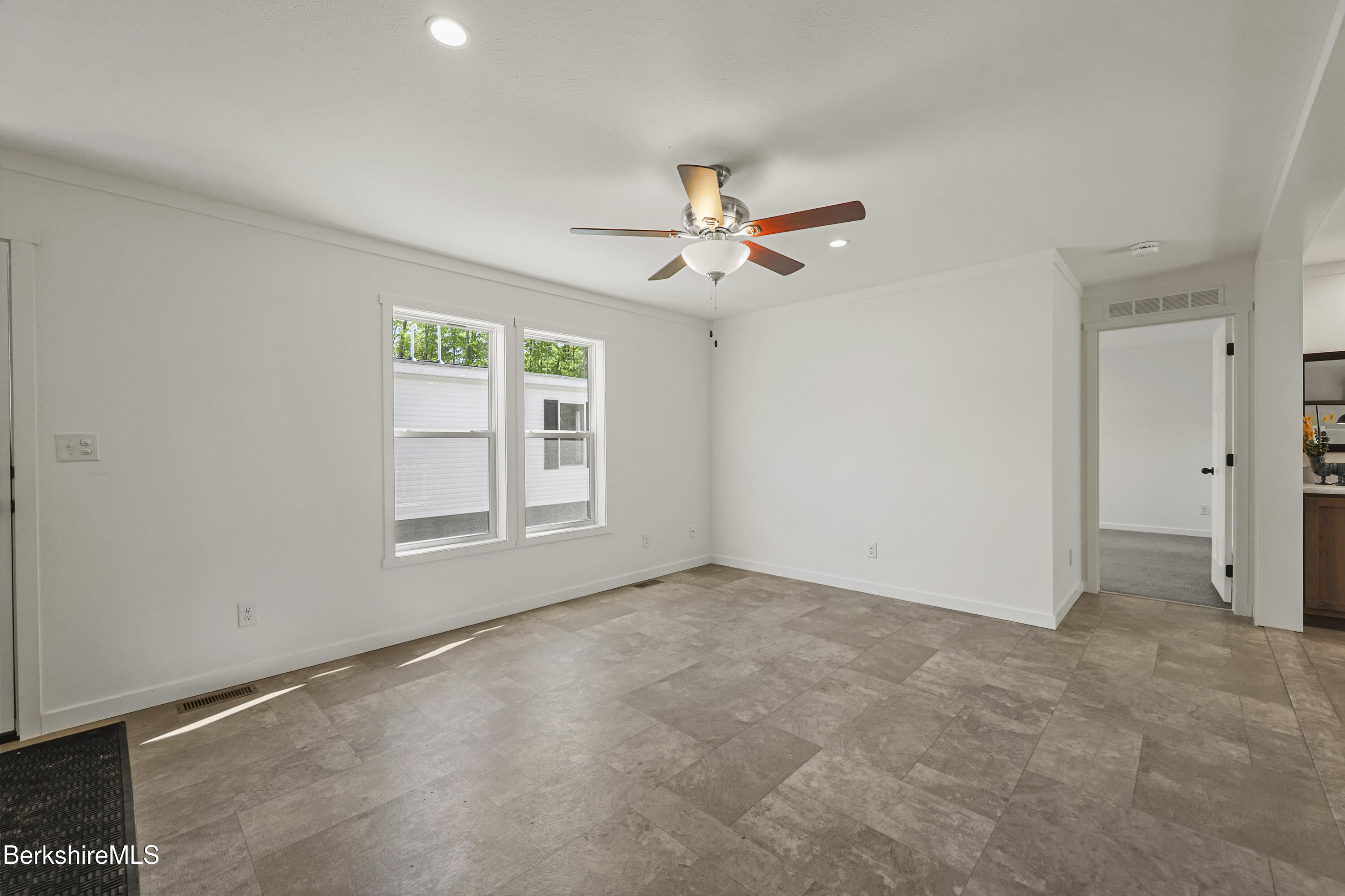 395 Cheshire Road, Unit 112 Pittsfield, MA 01201 - Photo 7 of 32 a view of an empty room with a window