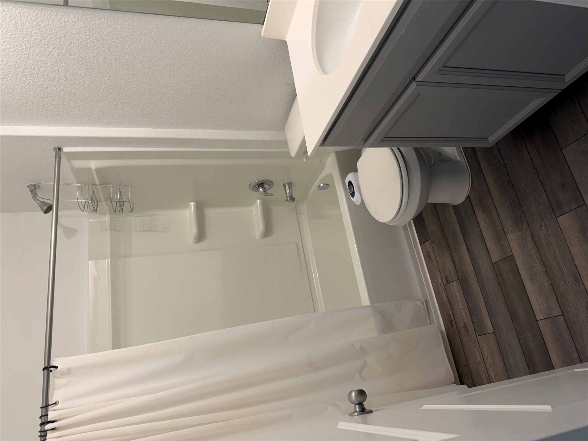 316 Harper Lane Georgetown, TX 78626 - Photo 16 of 21 Third full bath with a textured wall, vanity, dark wood finished floors, and shower / bath combo with shower curtain