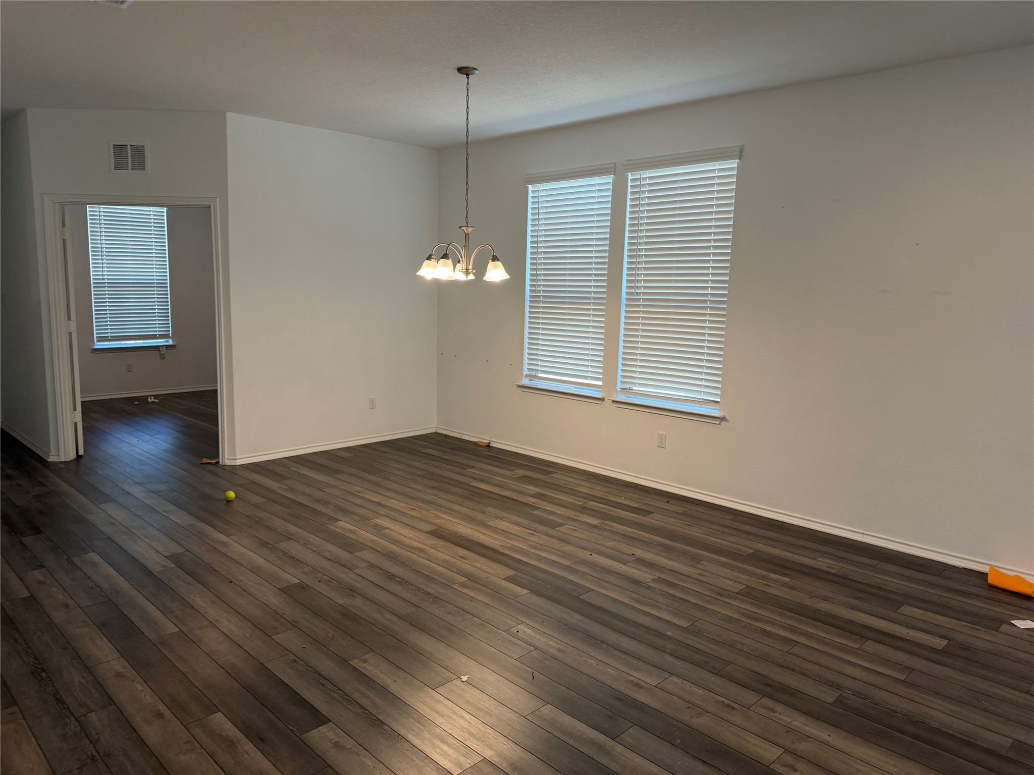 316 Harper Lane Georgetown, TX 78626 - Photo 4 of 21 Spare room with dark wood-style floors and suspended lighting