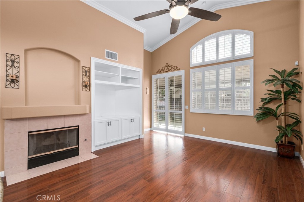 9403 Old Post Drive Rancho Cucamonga, CA 91730 - Photo 16 of 38 an empty room with wooden floor a ceiling fan and windows