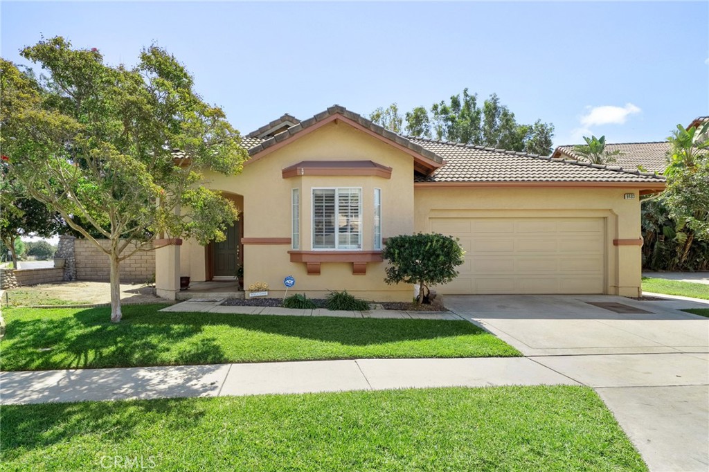 9403 Old Post Drive Rancho Cucamonga, CA 91730 - Photo 2 of 38 a front view of a house with a yard and potted plants