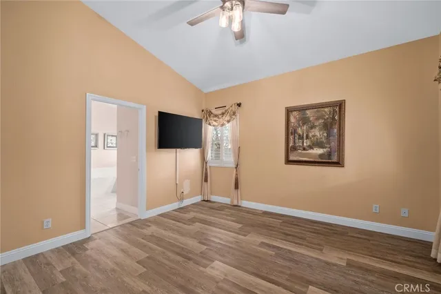 a view of a livingroom with wooden floor and chandelier